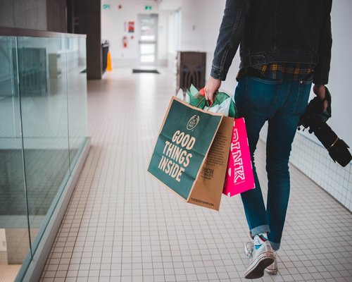 Person carrying groceries comfortably using two reusable bags