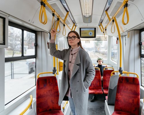 Commuter standing comfortably in a modern city tram